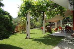 a group of tables and chairs under a pavilion at Villa's ground floor apartment with 60 qm swimming pool in Palaiokatoúna