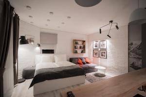 a bedroom with a large bed and a couch at Revelton Studios Karlovy Vary in Karlovy Vary