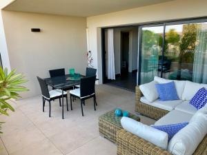 a living room with a couch and a table and chairs at Ô de Mer at My Luxury Home in Provence in La Ciotat