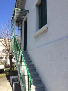 a stairway leading up to a building with a green railing at Studio Bassens in Bassens