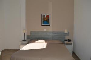 Postel nebo postele na pokoji v ubytování Hotel La Tavernetta