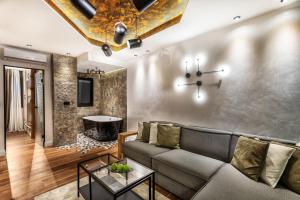 a living room with a couch and a table at One Luxury Suites in Belgrade
