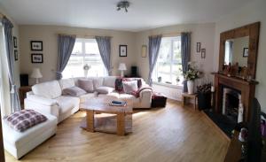 a living room with a white couch and a coffee table at Watersedge in Mulranny