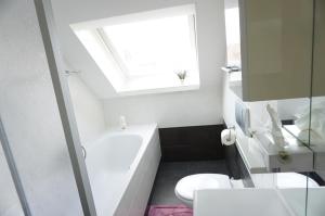 Un baño con lavabo, inodoro y ventana. en 4 a Kleikamp, en Königslutter am Elm