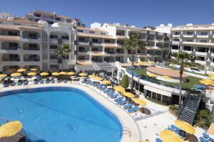 an aerial view of a hotel with a swimming pool and umbrellas at Luna Miramar Club in Albufeira