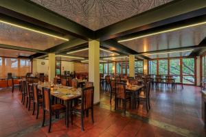 a restaurant with tables and chairs in a room at Hotel Elephant Reach in Tissamaharama