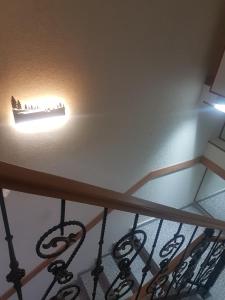 a staircase with a light on the ceiling at Hotel LEADER in Tbilisi City