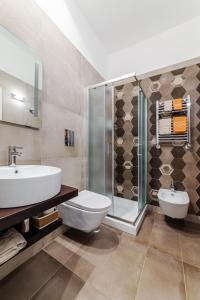 a bathroom with a toilet and a sink and a shower at La Rotonda da Sabrina B&B in Bari