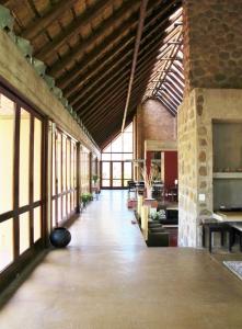 a large building with a large room with windows at Iwa Imfene Pvt Game Lodge, Welgevonden IMW2 in Welgevonden Game Reserve