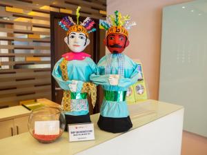 two statues of two people standing on a counter at d'primahotel WTC Mangga Dua in Jakarta