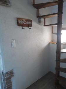 a staircase in a room with a sign on the wall at Pigeonnier Brens in Brens