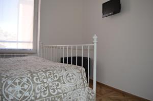 a bedroom with a bed and a tv on a wall at Casa Vacanze Matilda in Varazze