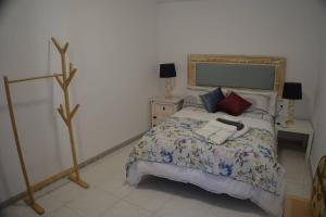 a bedroom with a bed and two lamps at SC Victoria II in Cáceres