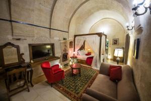 a bedroom with a bed and a couch in a room at Mira Cappadocia Hotel in Avanos