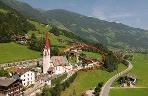 an aerial view of a small village with a church at Hotel Kirchbichlhof in Hippach