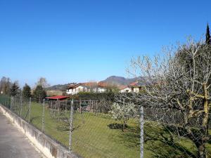 a fence in front of a yard with houses at Casa Fiorella in Stiava