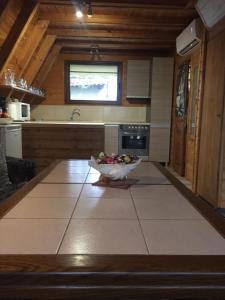 a kitchen with a bowl of fruit on the floor at Domek Letniskowy in Mrzeżyno