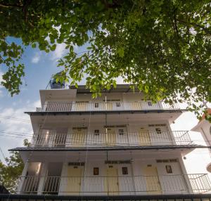 a tall white building with balconies at Gems 9 Airport Hotel in Nedumbassery