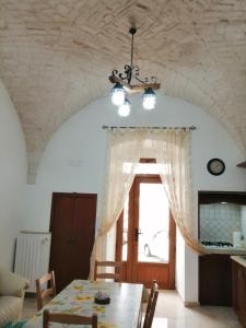 a dining room with a table and a window at Casa Nino in Martina Franca