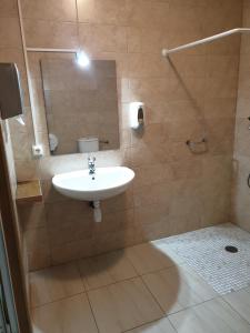 a bathroom with a sink and a shower with a mirror at Albergue Porta Real NO BIKE STORAGE in Santiago de Compostela +6 photos