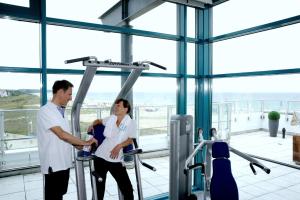 two people shaking hands in a gym at Hotel Neptun in Warnemünde