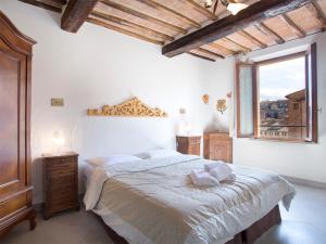 a bedroom with a large bed and a window at Nonna Pappa in Siena