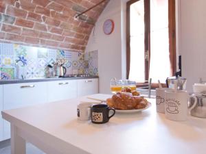 a kitchen with a table with a plate of food at Nonna Pappa in Siena +16 photos