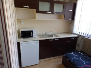 a small kitchen with a sink and a microwave at Mix Hotel in Vidin