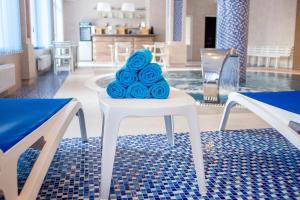 a pile of blue roses sitting on a white chair at Green Park Hotel & SPA in Truskavets