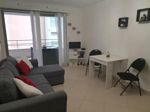 a living room with a couch and a table at Cocooning in Menton