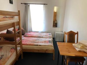 a bedroom with bunk beds and a table and a window at Zrcadlová Koza in Turnov