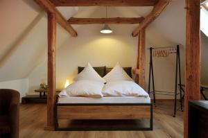 a bedroom with a bed with white pillows at FeWo Jung in Falkensee
