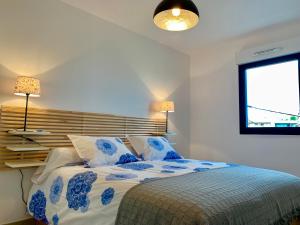 a bedroom with a bed with blue and white sheets at Ô de Mer at My Luxury Home in Provence in La Ciotat