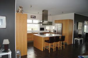 a kitchen with a island in the middle of it at Guesthouse Nordheimar in Selfoss