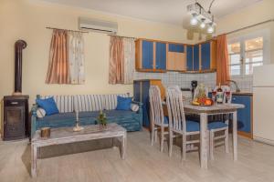 a kitchen and living room with a table and a couch at Augoustinos Villa in Zakynthos