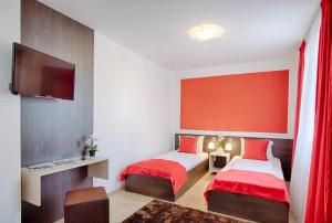 Posteľ alebo postele v izbe v ubytovaní Triple M Hotel