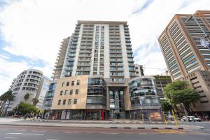 a large apartment building in the middle of a city at Icon Serviced Apartments Foreshore in Cape Town