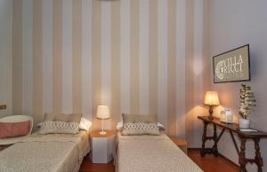 Postel nebo postele na pokoji v ubytování Villa Ricci Suites