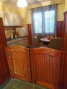 a kitchen with wooden cabinets and a table in a kitchen at Kuća za odmor Magdalena in Vrtlinovec