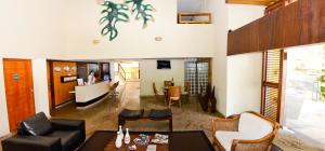 a living room with a couch and a table at Elegance Comfort Natal Beira Mar in Natal