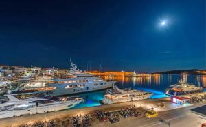 a group of boats docked at a marina at night at Naves Suites in Ermoupoli
