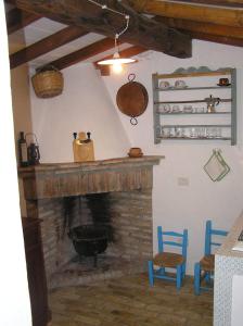 sala de estar con chimenea y 2 sillas azules en Bamboo House, en Teulada