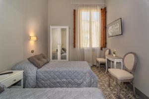 Postel nebo postele na pokoji v ubytování Villa Ricci Suites