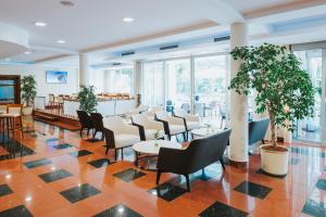 a lobby with chairs and tables and a bar at Hotel Ivka in Dubrovnik
