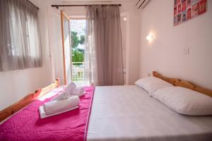 a bedroom with a large bed with two white towels on it at Myloi Loggou in Sykia Chalkidikis