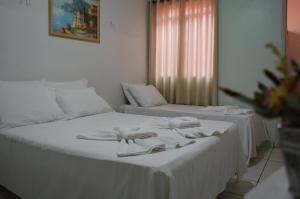 Postel nebo postele na pokoji v ubytování Hotel Confort Maringá