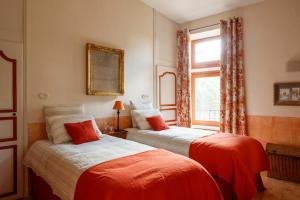 a bedroom with two beds and a window at Le Moulin de Pézenas - Pierres d'Histoire in Pézenas