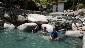 a group of children playing in the water at Baleh Boble Guesthouse in Banaue