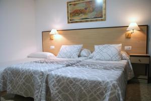 Postel nebo postele na pokoji v ubytování Hotel Carabela 2