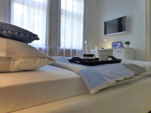 a bedroom with a bed with a flat screen tv at Konzul in Osijek